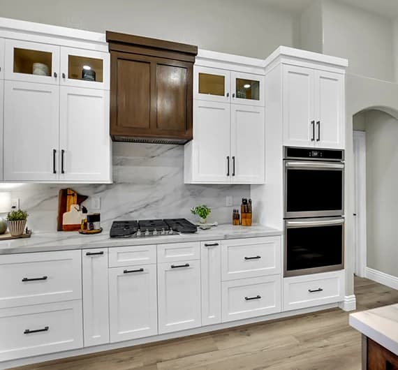 Centennial Hills kitchen remodel with white shaker cabinets, quartz backsplash, oven wall, and custom wood accent cabinetry