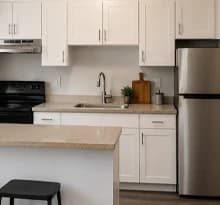 White stock or prefab kitchen cabinets in a simple same-footprint kitchen layout