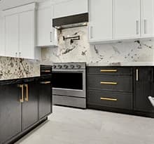 Full kitchen remodel with two-tone cabinets, slab backsplash, range, and new finishes