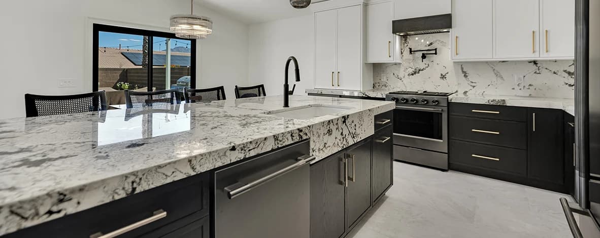 Two-tone kitchen cabinets coordinated with waterfall island, backsplash, range, and seating workflow