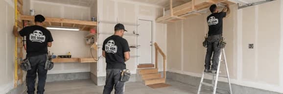 Three Big Horn Remodeling crew members working inside a garage conversion.
