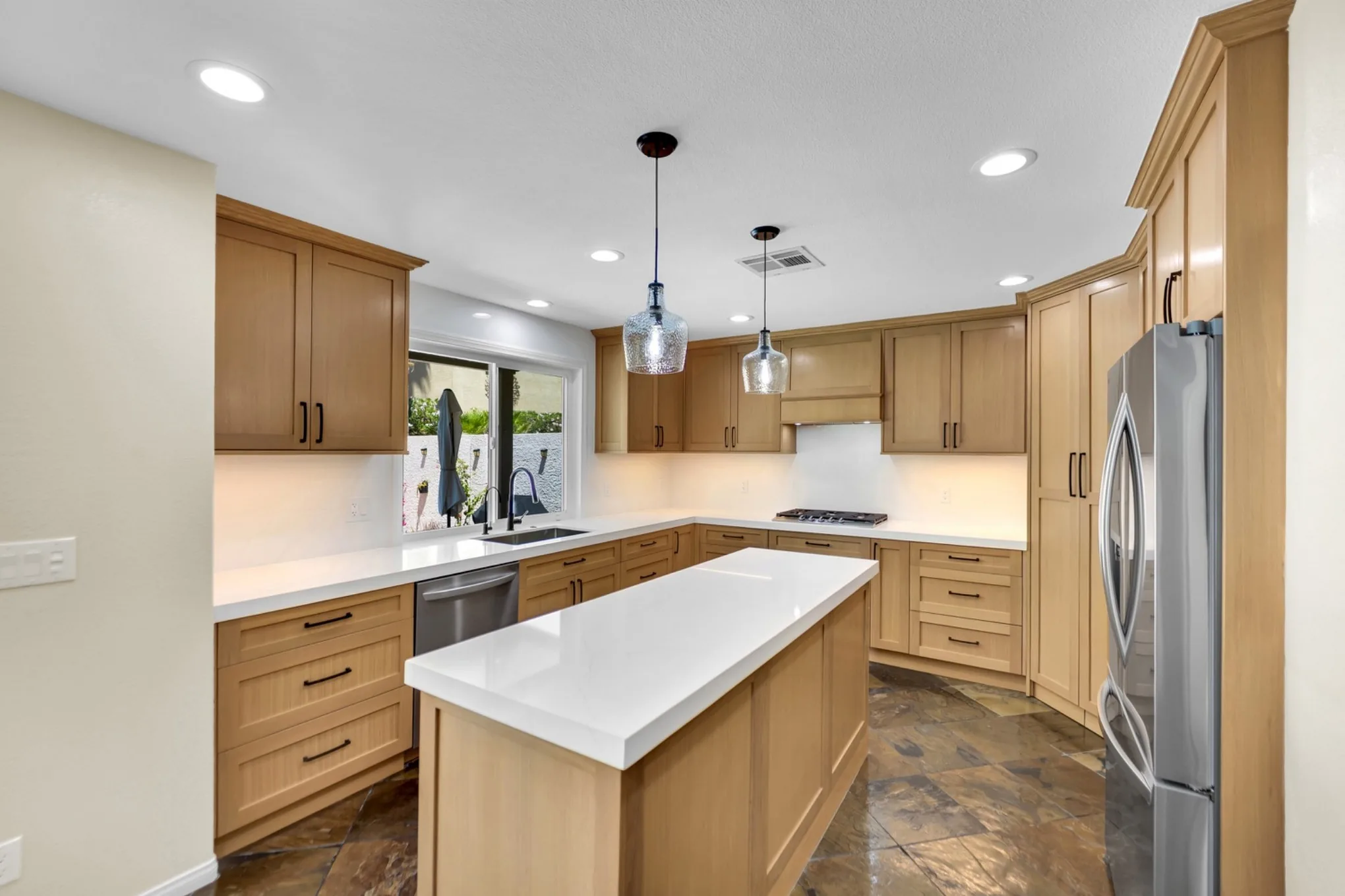 Completed Big Horn Remodeling kitchen with white oak cabinetry and a quartz island; an interior remodeling project