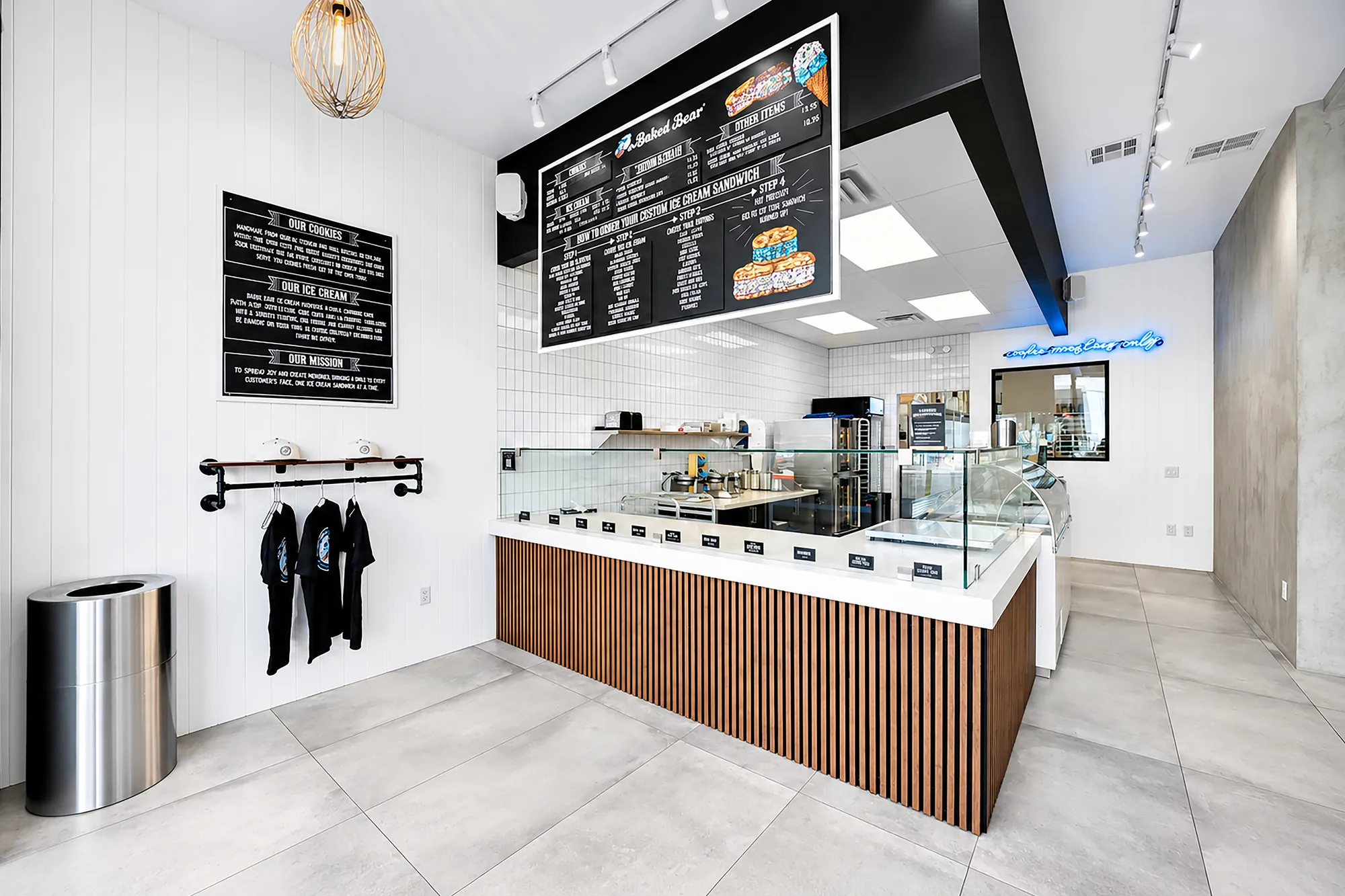 The Baked Bear Town Square service counter with wood-slat fronts, glass guards and white shiplap
