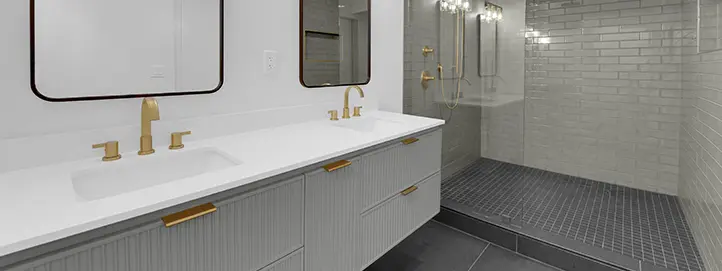 Primary bathroom remodel in Henderson with double vanity brass fixtures walk-in shower and full-height tile