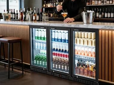 Back bar with beverage refrigerators, bottle display and bartender workspace