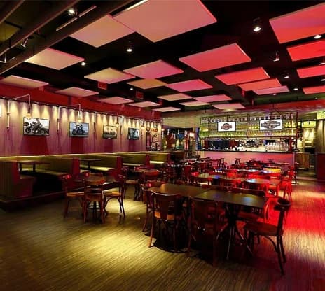 Finished restaurant dining room with red booths, tables and a bar