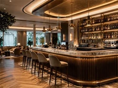 Finished restaurant bar with guest seating and a curved stone counter