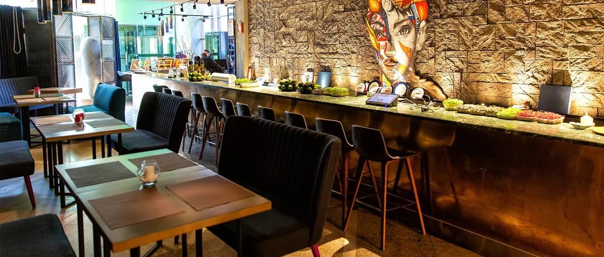Contemporary restaurant dining room with a long service counter and tables