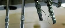 Fire-suppression nozzles and piping beneath a commercial kitchen hood