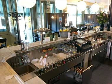 Under-bar work area with sinks, ice well, bottles and service equipment