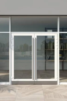 Double glass storefront doors with metal frames and a tiled entrance.