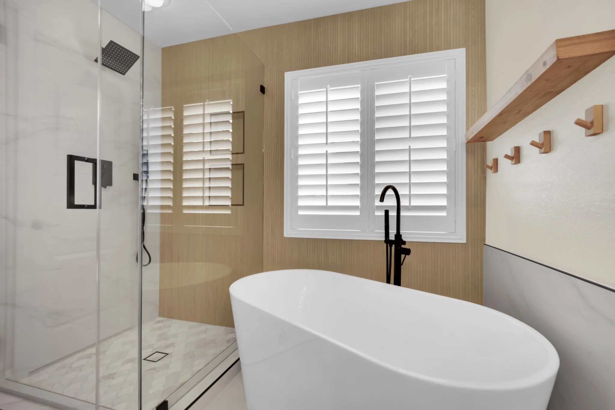 Tile shower pan with scallop mosaic floor, square drain, low curb, and frameless glass in a bathroom remodel