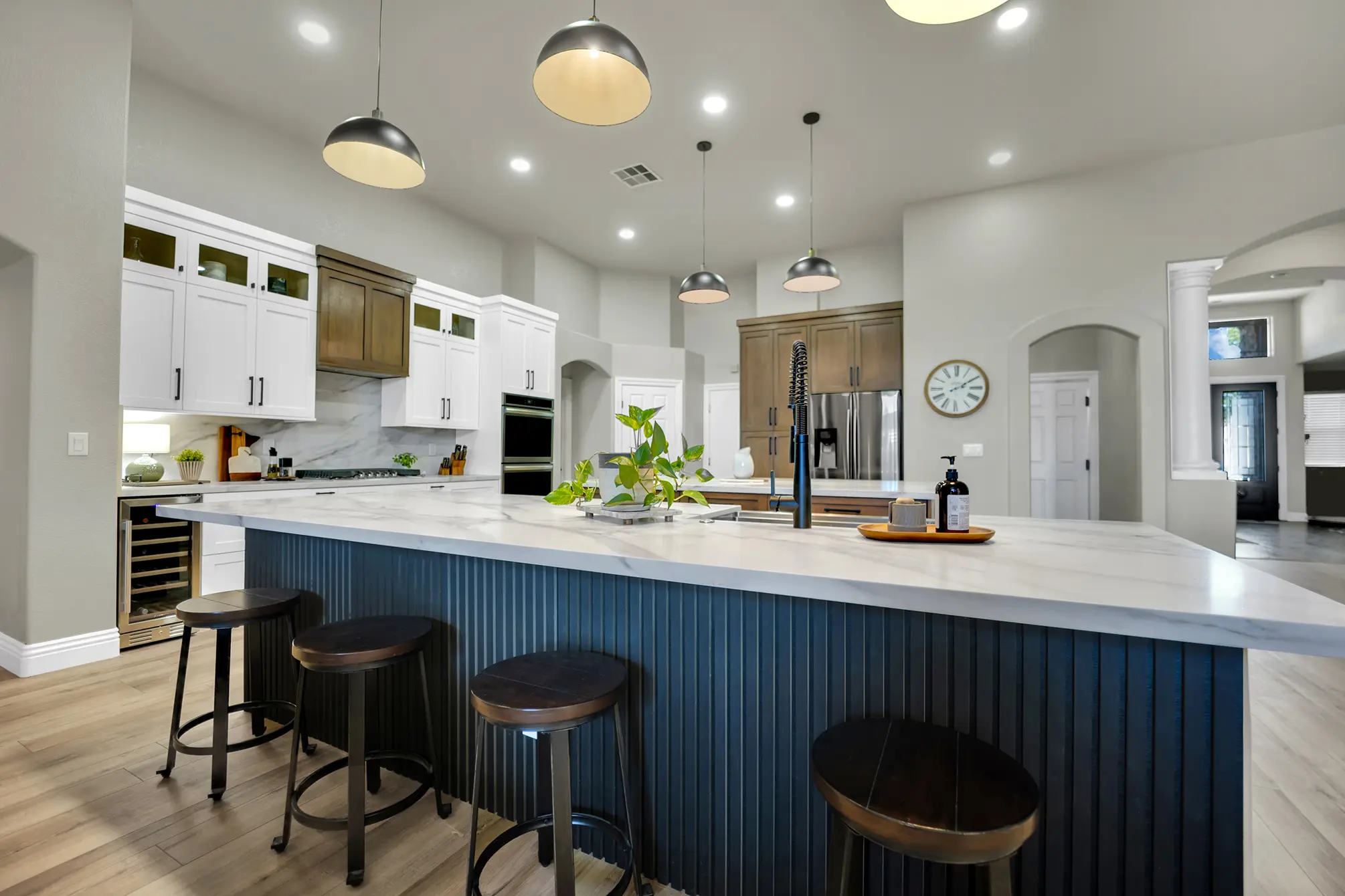 Centennial Hills kitchen remodel with blue island seating, quartz countertop, custom cabinets, and pendant lights
