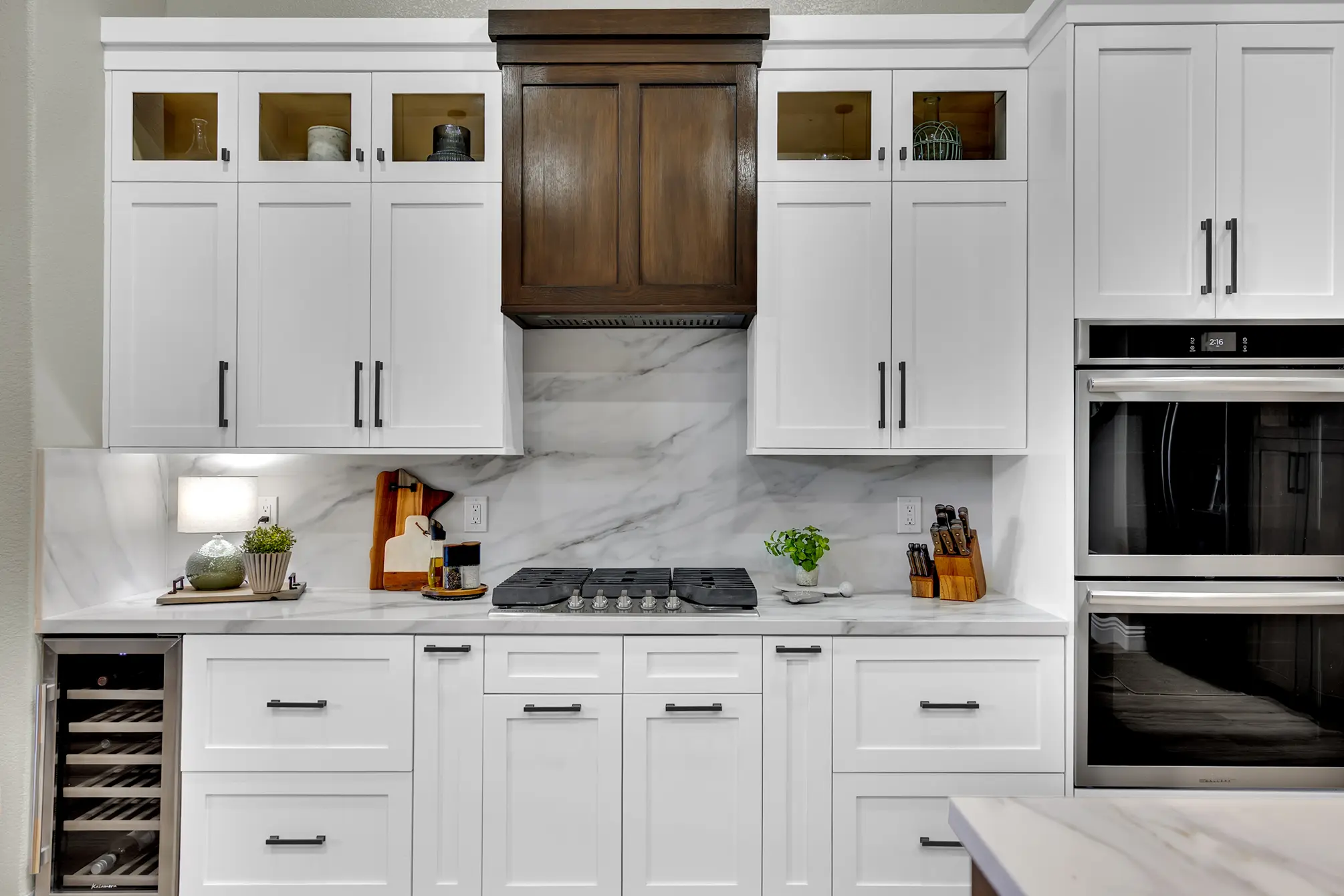 Centennial Hills kitchen remodel with Calacatta White Quartz countertop and backsplash, white HDF shaker cabinets, and custom wood cabinets