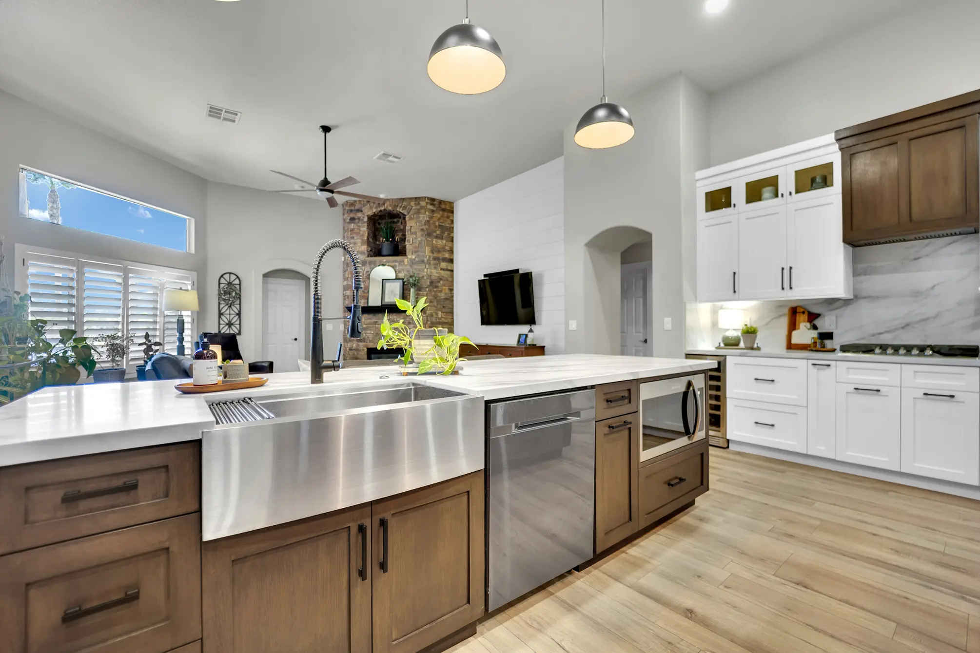 Two-island kitchen remodel with farmhouse sink, LVP flooring, and custom cabinets in Las Vegas