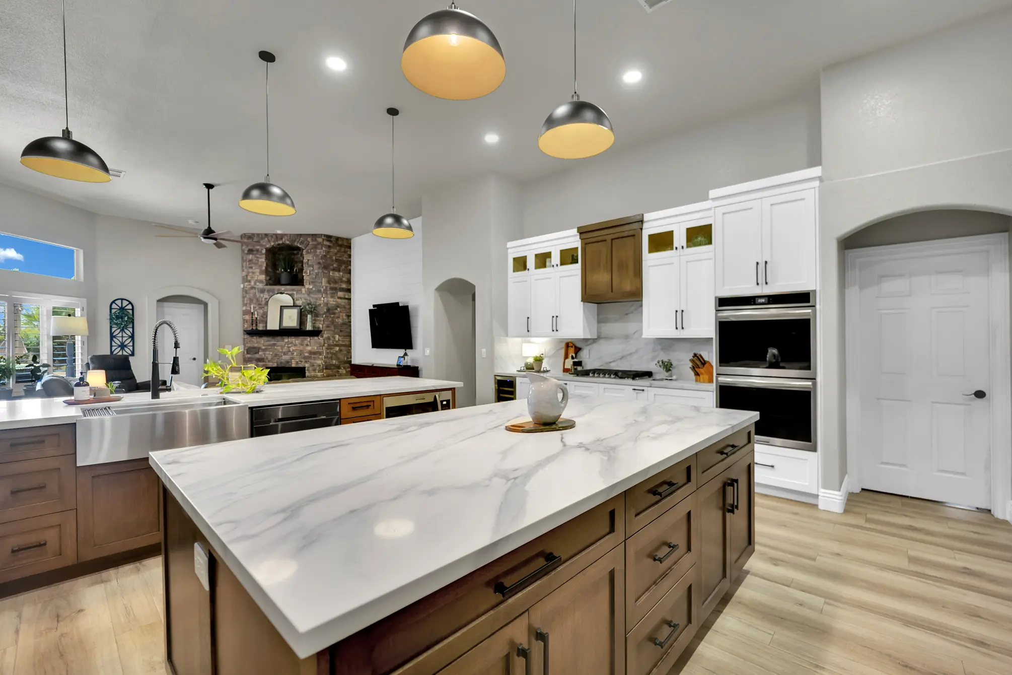Two-island Centennial Hills kitchen remodel with white oak island cabinetry, Calacatta White Quartz, pendant lighting, and custom cabinets