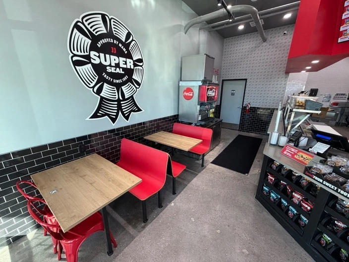 Jimmy John's dining area with black subway tile and branded wall graphic in Las Vegas