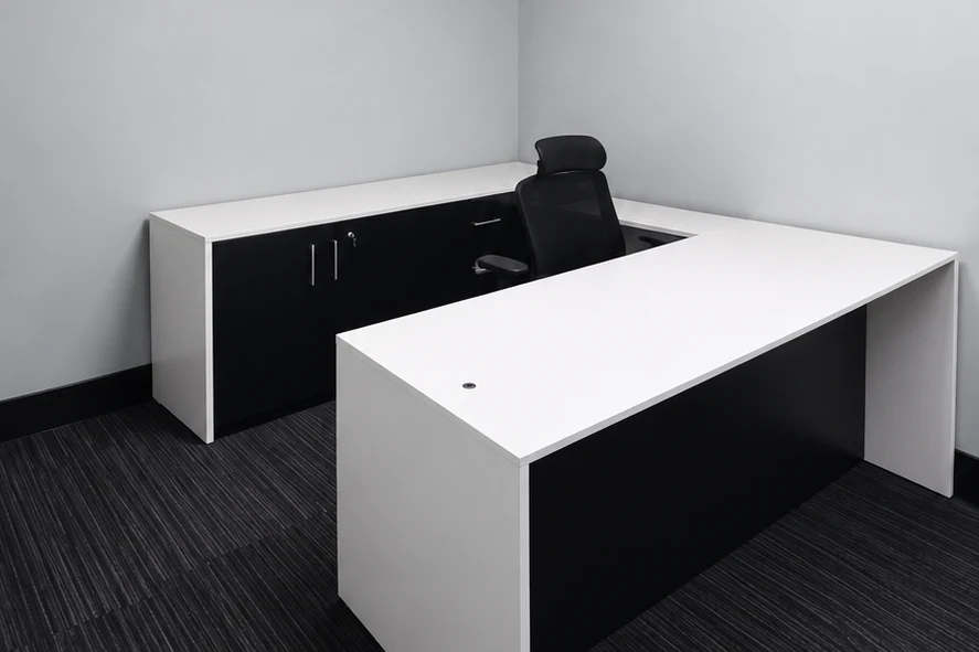 Private office with dark striped carpet, gray walls, and a white desk with black base panels.