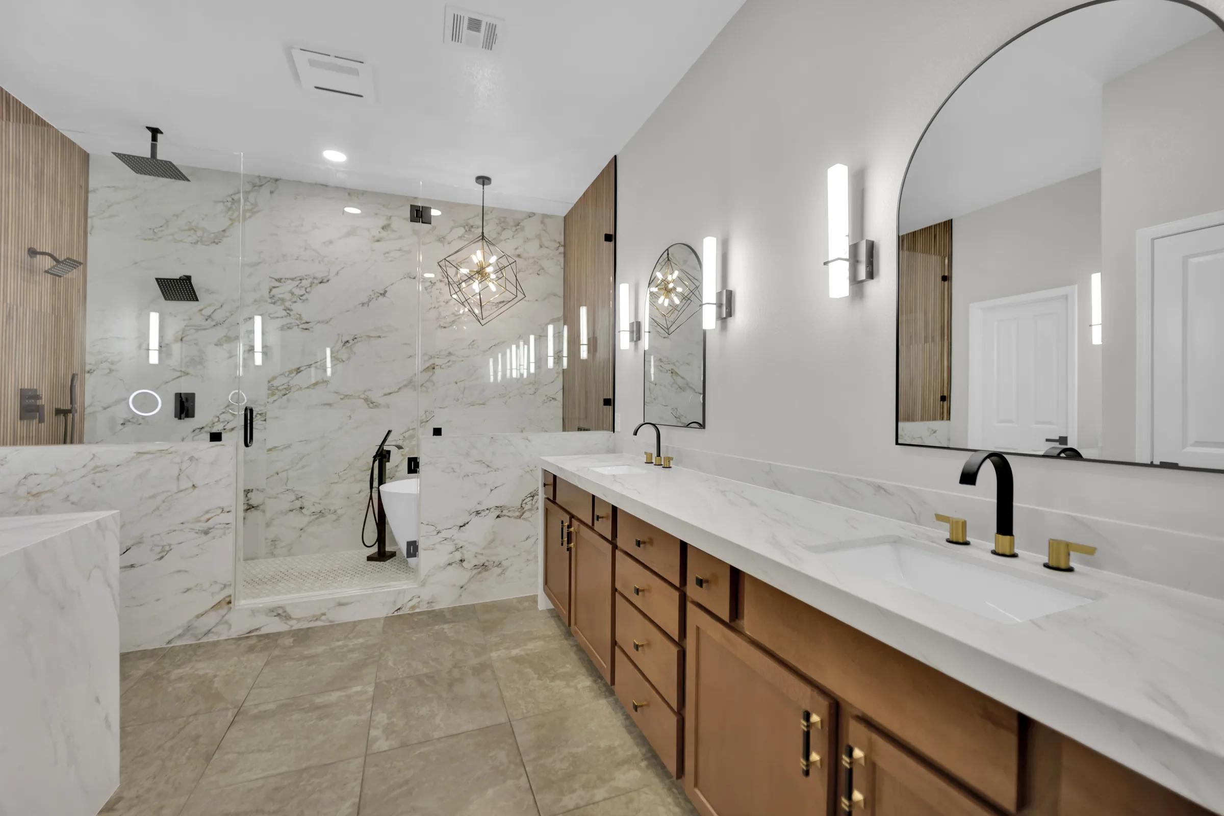 Completed North Cheyenne bathroom with a wet room, wood vanity, and retained floor tile.