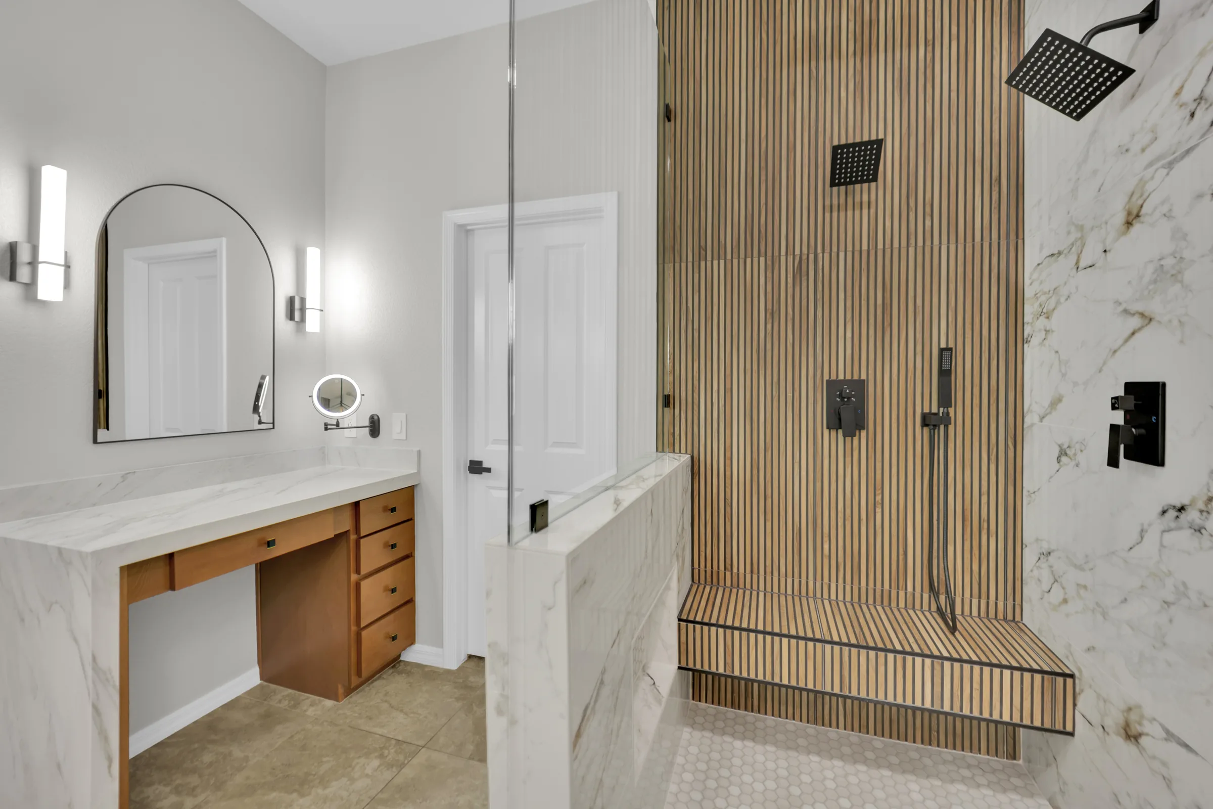 Wood-look tiled shower bench beside a pony wall and retained makeup vanity.