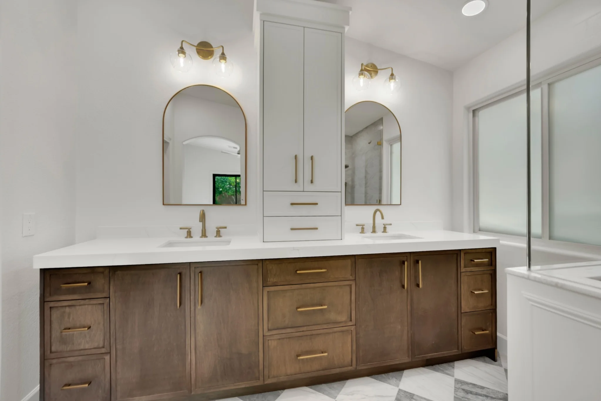 Brown Mist white oak vanity cabinets with gold hardware and quartz countertop