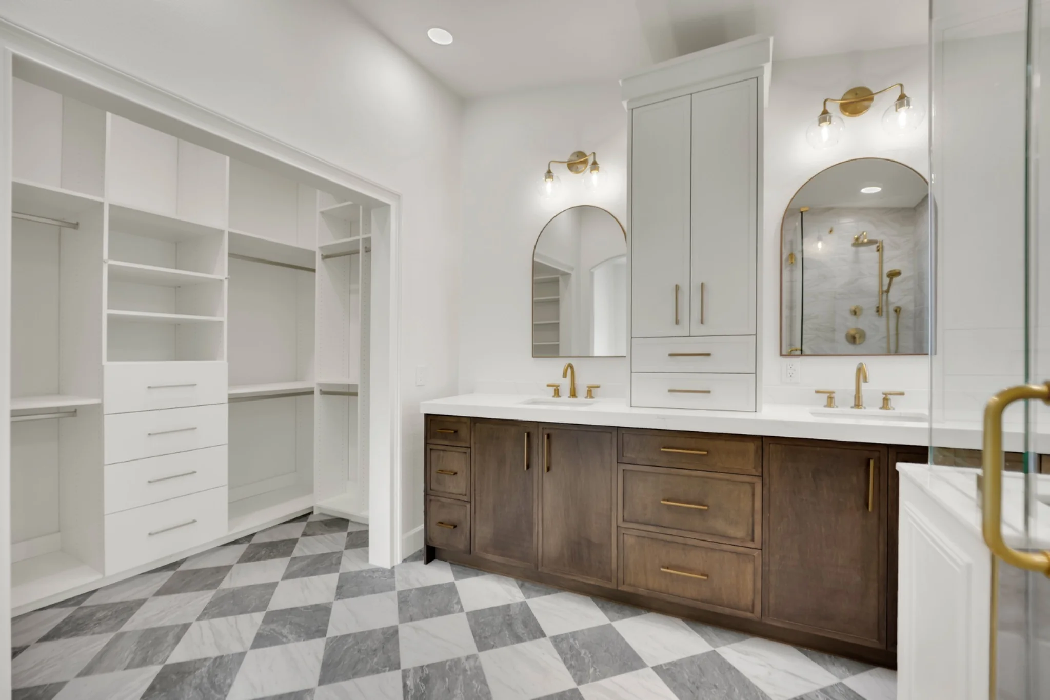 Checkered marble bathroom floor with white oak vanity and custom closet opening