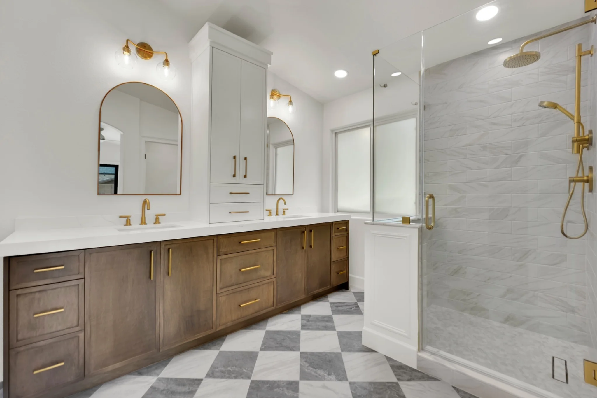 Full primary bathroom remodel with custom glass shower, marble tile, white oak vanity, and checkered marble floor