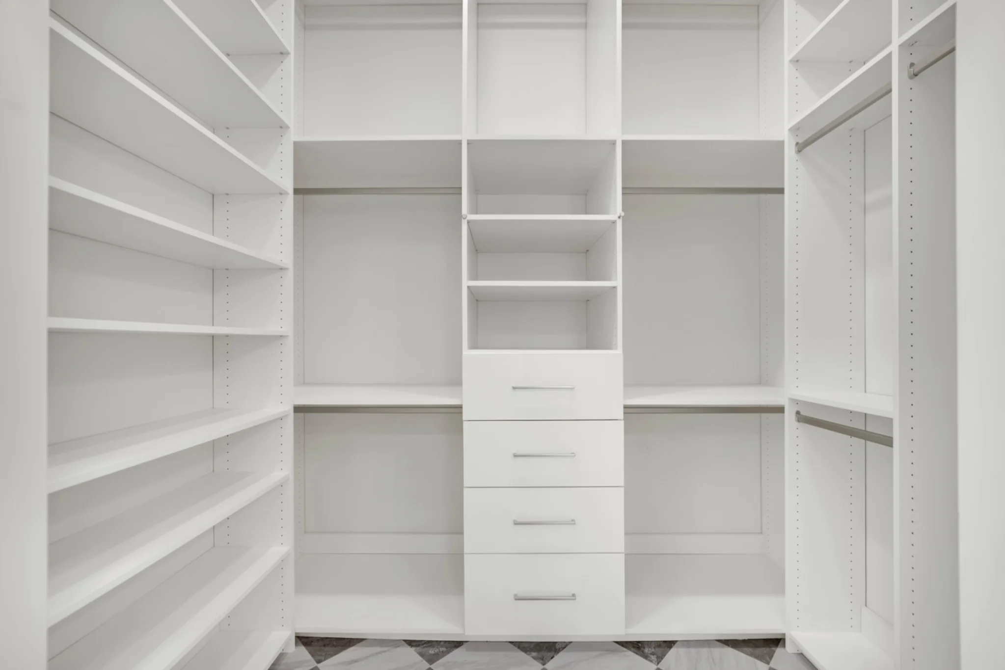 White custom closet shelving and drawers completed during a primary bathroom suite remodel