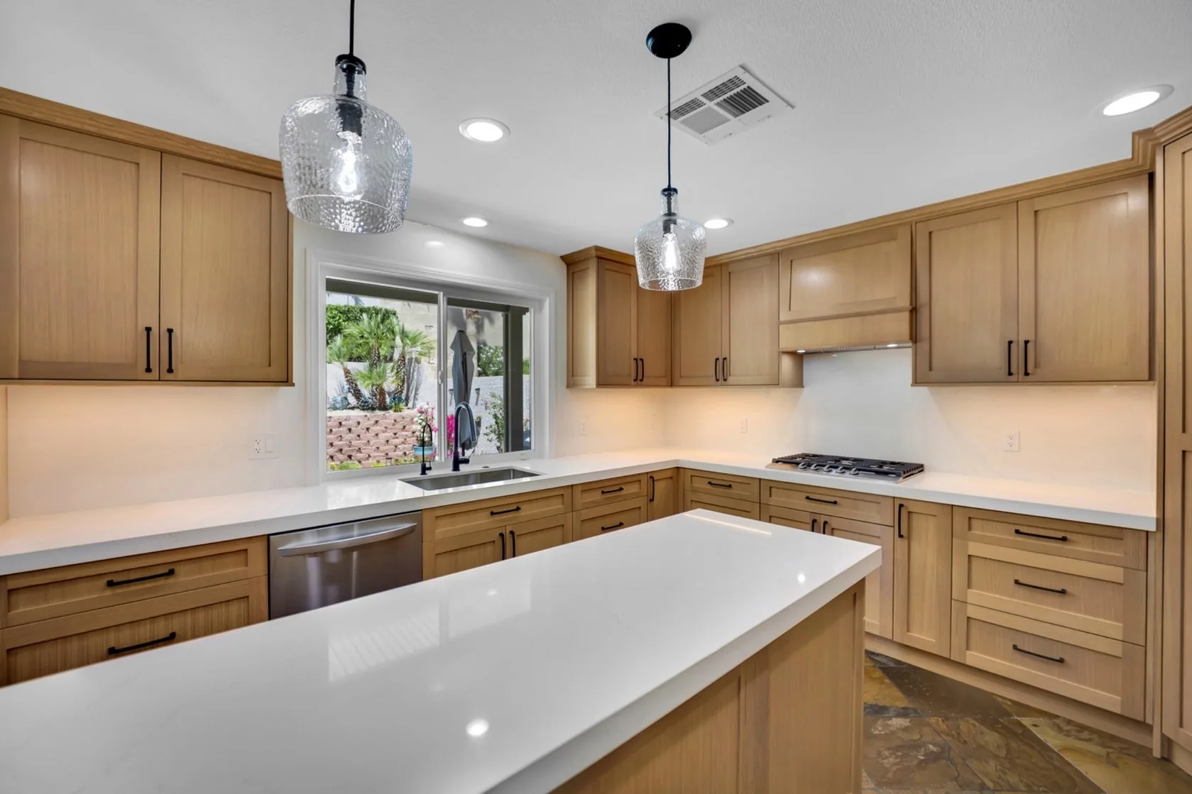 Custom kitchen remodel with rift white oak cabinets, island, pendants, and under-cabinet lighting