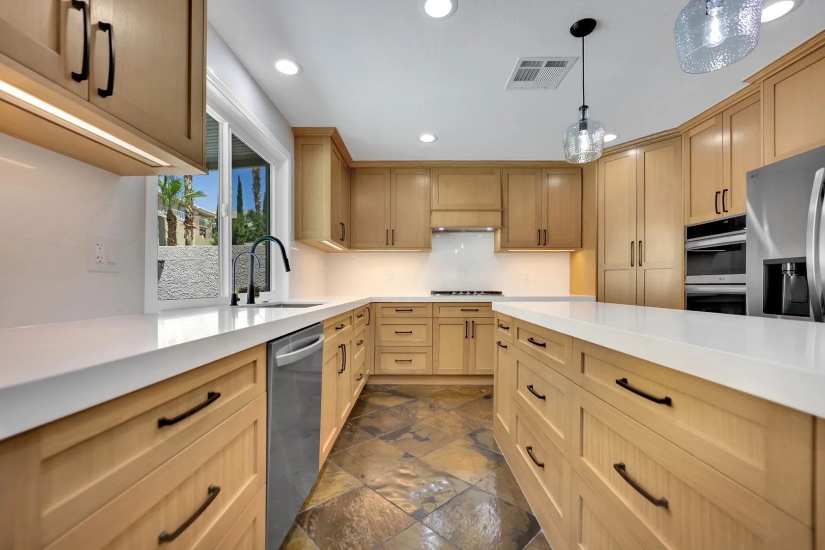 Under-cabinet lighting integrated into custom rift white oak kitchen cabinets