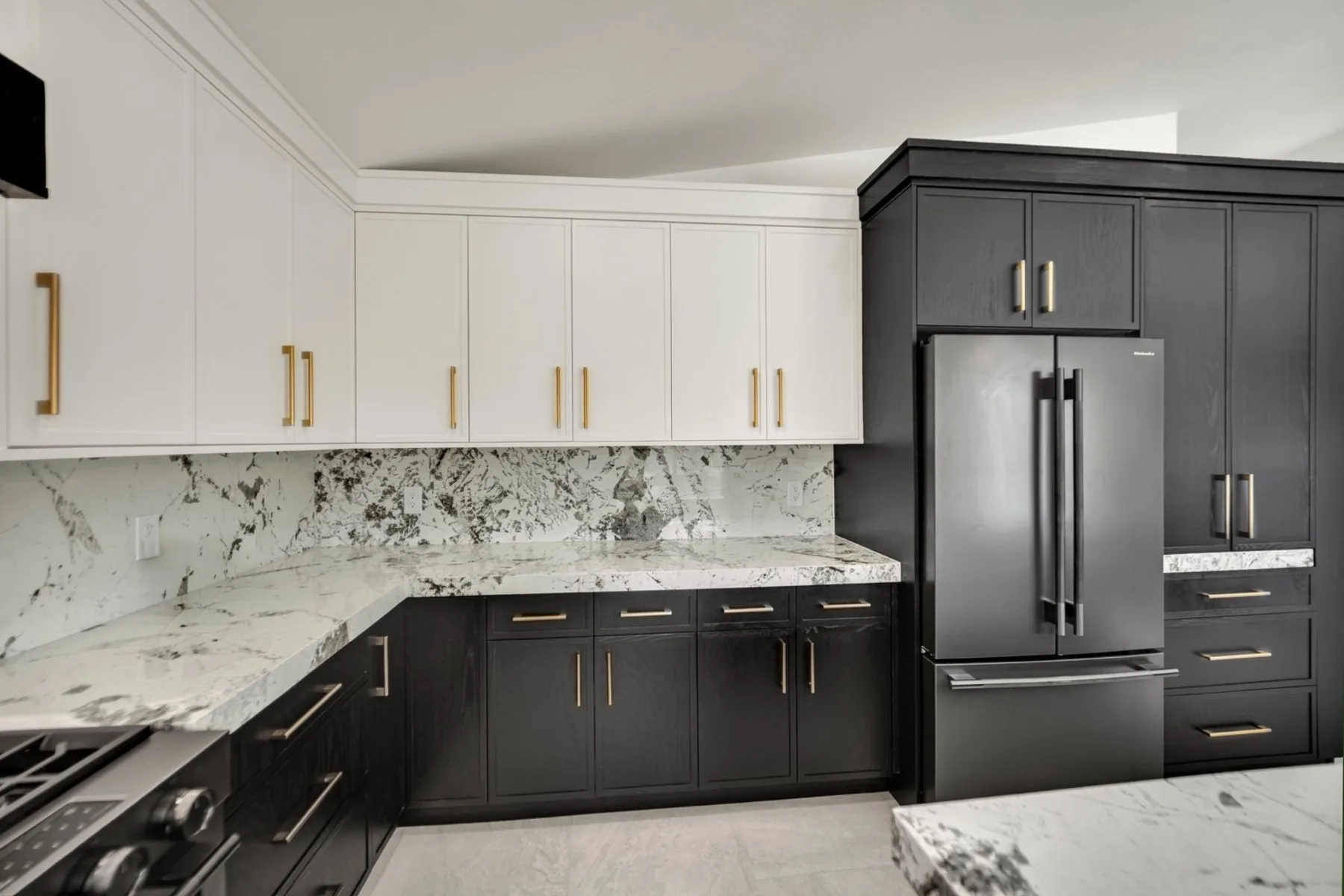Fully custom refrigerator wall with dark painted cabinetry, brass hardware, and integrated appliance storage in Summerlin