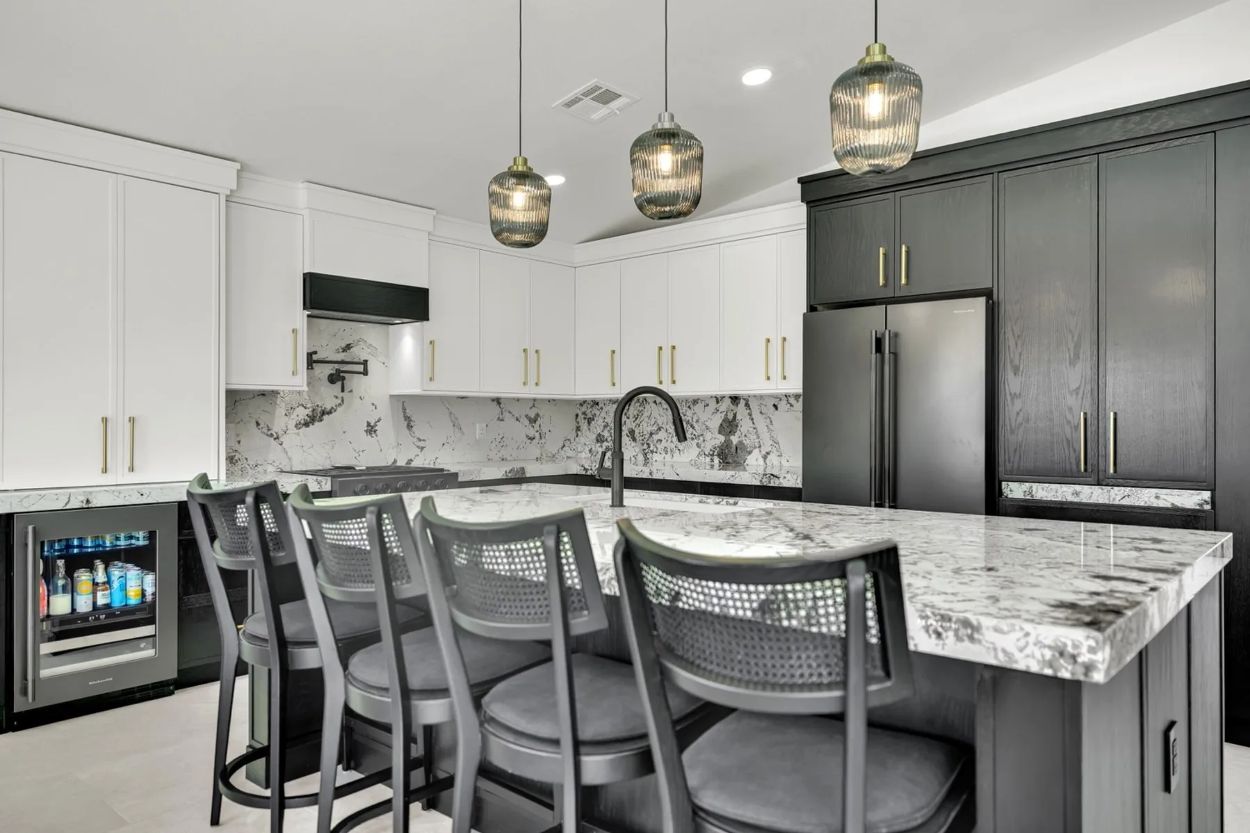 Wide Summerlin kitchen remodel view with custom island seating, granite countertop, painted cabinetry, and brass hardware