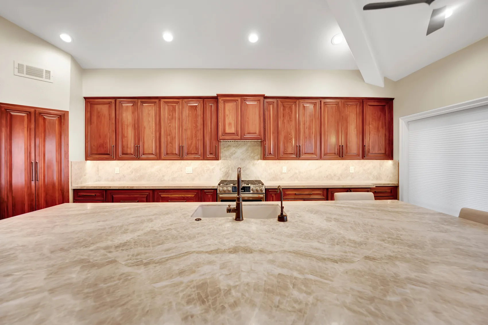 GE Cafe appliances with custom maple cabinets and under-cabinet lighting